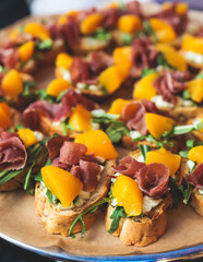 Beautifully decorated banquet catering table, with variety of with different food snacks appetizers on corporate birthday party event or wedding celebration, canape, salad, delicatessen setting