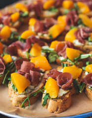 Beautifully decorated banquet catering table, with variety of with different food snacks appetizers on corporate birthday party event or wedding celebration, canape, salad, delicatessen setting