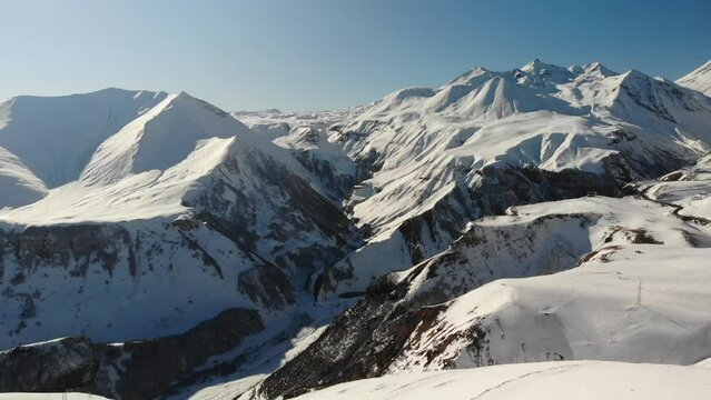 Aerial video over ski resort and snowy mountains in Gudauri Georgia