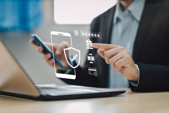 Concept of cyber crime and cyber security. Hand using laptop and smartphone for internet banking money transaction with two-step verification,  authentication, information security and encryption.