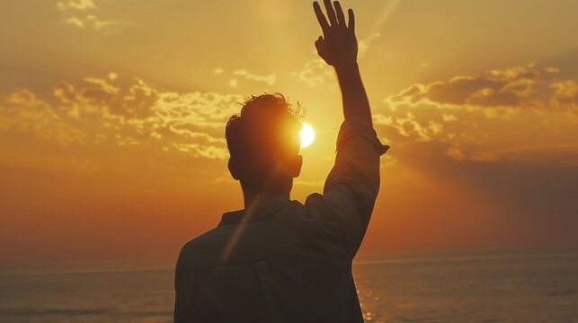 Silhouette of a person waving at a golden sunset by the ocean, capturing a peaceful and heartwarming moment of farewell.