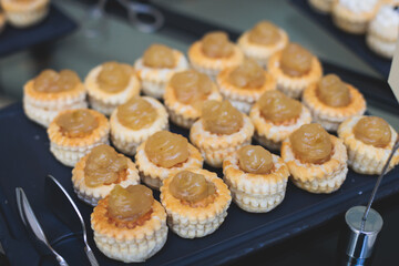 Set of coffee break in the hotel during conference meeting, with tea and coffee catering, decorated catering banquet table with variety of different pastry and bakery, with croissants and cookies