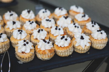 Set of coffee break in the hotel during conference meeting, with tea and coffee catering, decorated catering banquet table with variety of different pastry and bakery, with croissants and cookies