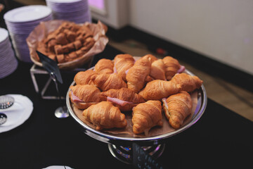 Set of coffee break in the hotel during conference meeting, with tea and coffee catering, decorated catering banquet table with variety of different pastry and bakery, with croissants cookies