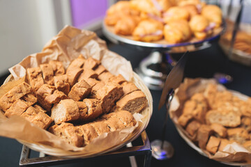 Set of coffee break in the hotel during conference meeting, with tea and coffee catering, decorated catering banquet table with variety of different pastry and bakery, with croissants cookies