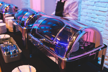 Naklejka premium Beautifully decorated catering banquet table with different main course hot food dishes and garnish, with rice, chicken, salmon fish, lamb, vegetables and kebab on party event wedding celebration