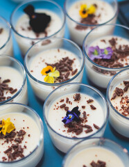 Beautiful multicolored decorated baked sweet tasty candy bar dessert selection with cake, pie and pastries selection, catering banquet table on kids children party, coffee break buffet at a conference