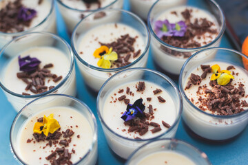Beautiful multicolored decorated baked sweet tasty candy bar dessert selection with cake, pie and pastries selection, catering banquet table on kids children party, coffee break buffet at a conference
