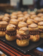 Beautiful multicolored decorated baked sweet tasty candy bar dessert selection with cake, pie and pastries selection, catering banquet table on kids children party, coffee break buffet at a conference
