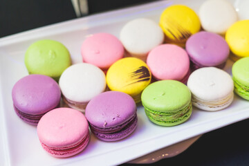 Beautiful multicolored decorated baked sweet tasty candy bar dessert selection with cake, pie and pastries selection, catering banquet table on kids children party, coffee break buffet at a conference