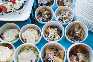 Beautifully decorated luxury banquet catering table, with variety of with different food snacks appetizers on corporate birthday party event wedding celebration, canape, salad, delicatessen variety