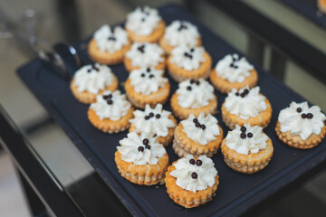 Beautifully decorated luxury banquet catering table, with variety of with different food snacks appetizers on corporate birthday party event wedding celebration, canape, salad, delicatessen variety