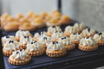 Beautifully decorated luxury banquet catering table, with variety of with different food snacks appetizers on corporate birthday party event wedding celebration, canape, salad, delicatessen variety