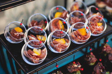 Beautifully decorated luxury banquet catering table, with variety of with different food snacks appetizers on corporate birthday party event wedding celebration, canape, salad, delicatessen variety