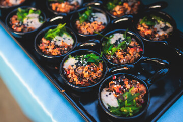 Beautifully decorated luxury banquet catering table, with variety of with different food snacks appetizers on corporate birthday party event wedding celebration, canape, salad, delicatessen variety