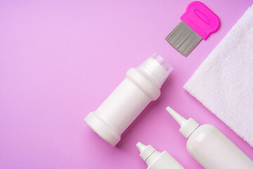 Anti lice combs and towel on pink background