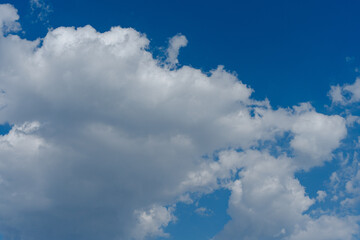 Fluffy white clouds in a bright blue sky