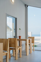 Cafe interior with wooden furniture and potted plant