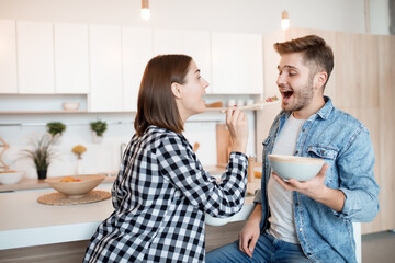 young happy man and woman in kitchen, breakfast, couple together in morning