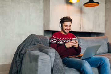 young attractive smiling man on sofa at home