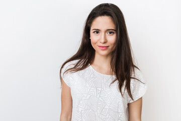 Fototapeta premium close up portrait of stylish young pretty woman smiling in white t-shirt, isolated, natural look, long brown hair