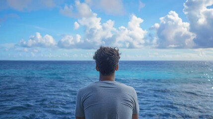 Fototapeta premium a man lost in thought, gazing out at a vast ocean