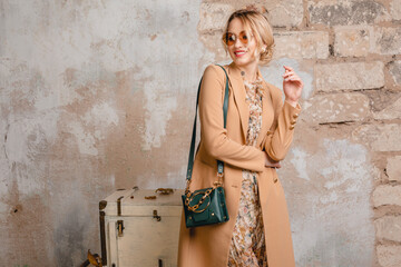 attractive stylish blonde woman in beige coat, spring autumn fashion trend