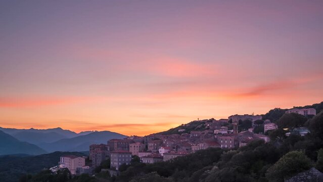 Time-lapse of a beautiful sunrise over the town of Sartene in Corsica and the Bavella mountains in the distance