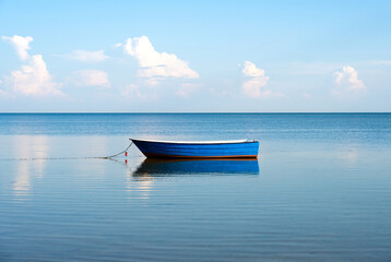 lonely fish boat on calm Baltic sea on Bay of Puck from Hel peninsula in Poland