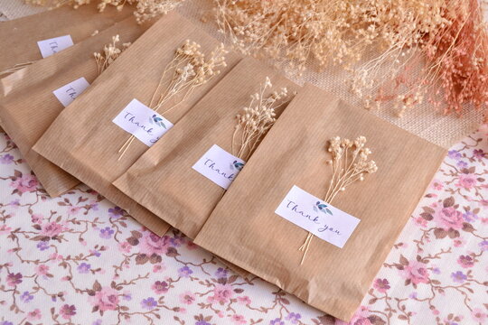 Wedding  celebration favors packaging in craft bags with custom label and dry flowers decoration, ecological party diy handmade souvenirs in natural color, guest small gifts easy ideas