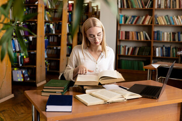 close-up of a young girl student holding a book in her hands, showcasing her passion for...