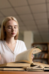close-up of a young girl student holding a book in her hands, showcasing her passion for...