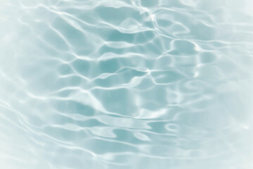 Obraz premium Blue water with ripples on the surface. Defocus blurred transparent blue colored clear calm water surface texture with splashes and bubbles. Water waves with shining pattern texture background.