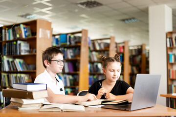 A group of schoolchildren at an extracurricular lesson. Classmates. Children read books and study...