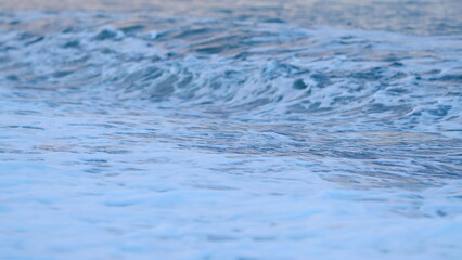 Sea Wave With Blue Water Of Ocean Crashing. Waves Coming Into The Beach At Sunset. Summer Beach Nature. Static view.