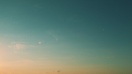 Intense dramatic panoramic sunset. Abstract different shades clouds at sunset sky background.