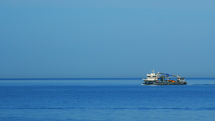Fototapeta premium Fisherman Boat In The Black Sea. Lonely Fishing Boat Sails On The Sea With Nets On Board. Still.