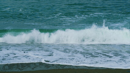 Multi-Colored Round Sea Pebble On Sea Coast. Wave Leaves White Marks. Still.