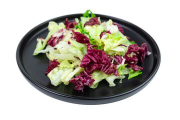 Vegan leaf salad on black plate isolated on white