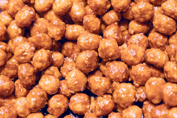 Pile of peanut balls in sugar. Delicious snack made from peanuts