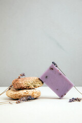 Handmade soap from natural ingredients, various herbs, lavender. Concept of sustainable use, bath product on concrete background. Front view