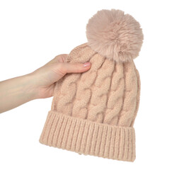 Beige pink warm hat in hand on white background isolation