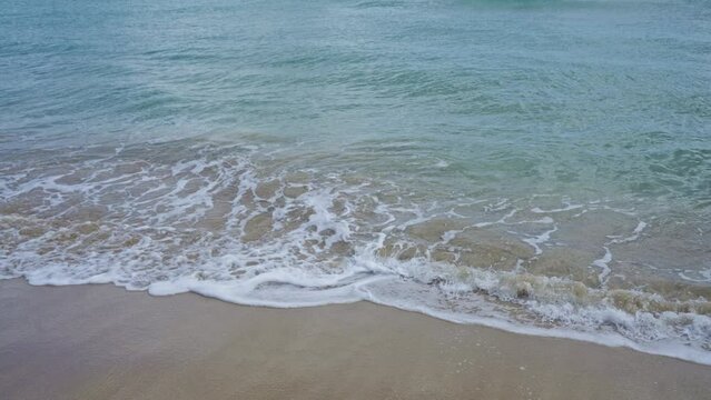 The serene shore of pescoluse beach in salento, puglia, italy, showcasing gentle waves against the sandy beach on a calm day.