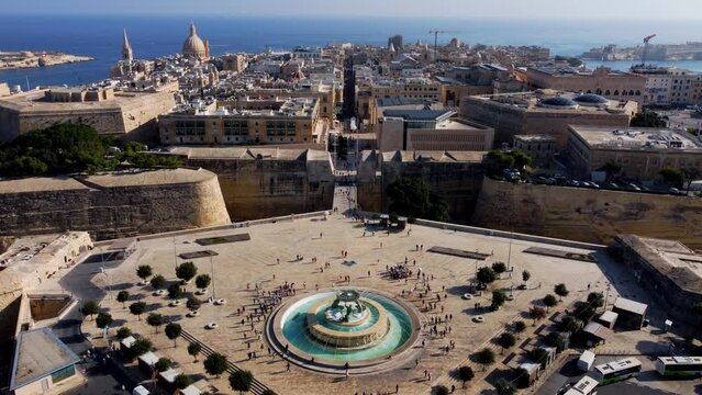 Aerial drone view of Valletta - capital of Malta island Europe, Mediterranean sea main church, dome, view of the Triton Fountain in the city center