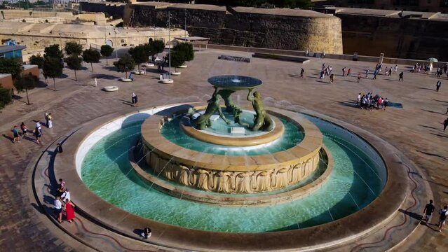 Aerial drone view of Valletta - capital of Malta island Europe, Mediterranean sea main church, dome. Detail view of the Triton Fountain in the city center