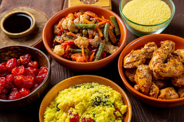 Traditional Moroccan lunch couscous with schofruits vegetables stewed chicken in sauce and dried fruits