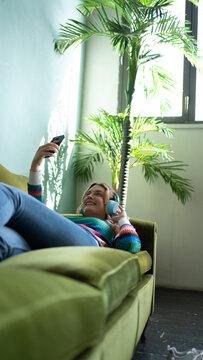 Young woman relaxing with music at a cozy home setting