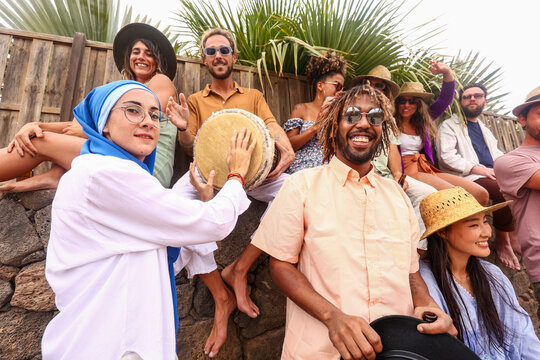Diverse cheerful group of people enjoying a party with live music outdoors