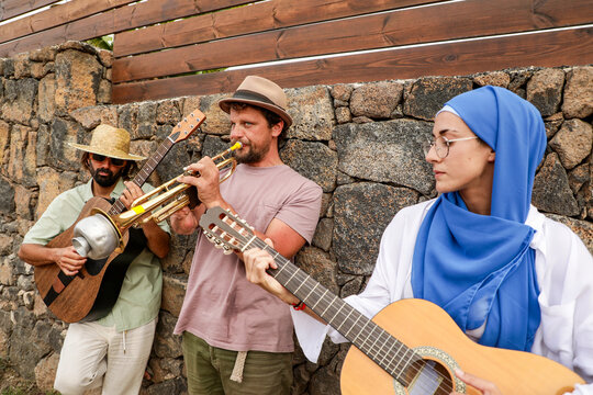 Multiethnic Friends Enjoy Music and Social Gathering Outdoors