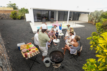 Diverse friends enjoying BBQ and music outdoors by the pool
